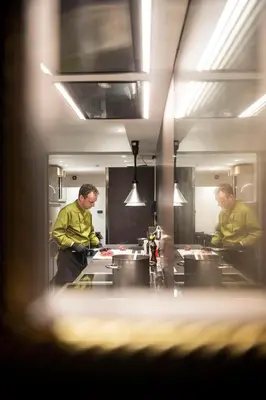 a person in a mirror in a restaurant with a table at Alpstay - Hotel Acadia - Adults Mountain Home in Selva di Val Gardena