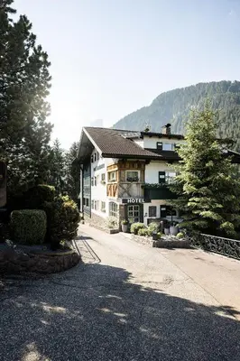 a hotel in the mountains covered in snow at Alpstay - Chalet Hotel Hartmann - Adults Only in Ortisei