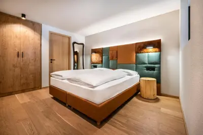 a bedroom with a large bed in a room at Ciasa Anteriol NEW SUMMER 2025 in San Cassiano