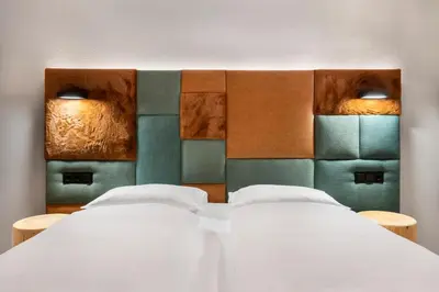 two beds in a room with a head board at Ciasa Anteriol NEW SUMMER 2025 in San Cassiano