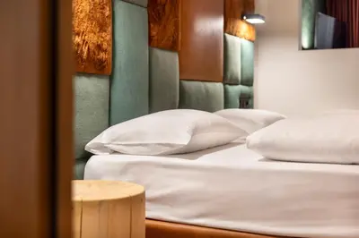 three beds in a room with white pillows at Ciasa Anteriol NEW SUMMER 2025 in San Cassiano