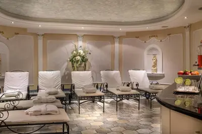 a room with a bunch of chairs and a table at Aktiv & Relax Hotel Hubertus in Villandro