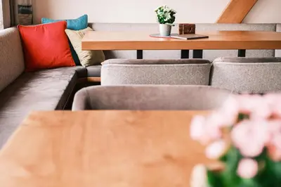 a table and chairs with pillows and a table at Kristiania Small Dolomites Hotel in Selva di Val Gardena