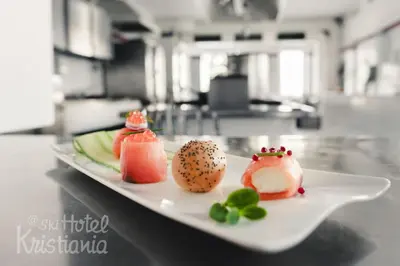 a white plate with sushi on a table at Kristiania Small Dolomites Hotel in Selva di Val Gardena