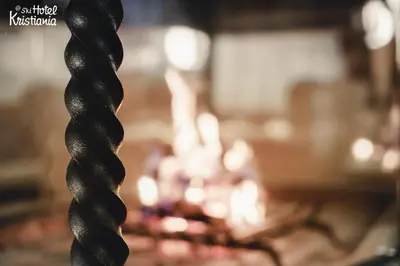 a blurry picture of a living room with a fire at Kristiania Small Dolomites Hotel in Selva di Val Gardena