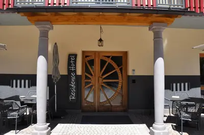 a front door of a restaurant with tables and chairs at Hotel Residence Rosa in San Lugano