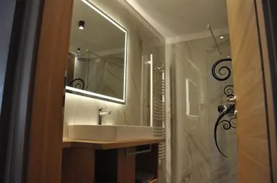 a bathroom with a sink and a mirror at Hotel Residence Rosa in San Lugano