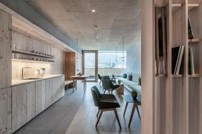 a kitchen and living room with a couch and a table at Hotel Restaurant Langgenhof in Brunico