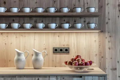 a shelf with two vases and a bowl of apples at Hotel Restaurant Langgenhof in Brunico
