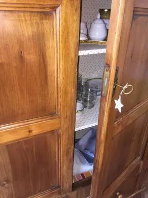 an open wooden cabinet with a star on the door at b&b Casa Tavernaro in Fiera di Primiero