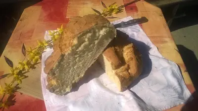 two slices of bread on a table with a knife at b&b Casa Tavernaro in Fiera di Primiero