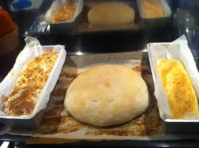 three trays of food sitting on a counter at b&b Casa Tavernaro in Fiera di Primiero