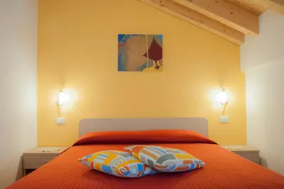 a bedroom with a bed with two pillows on it at b&b Casa Tavernaro in Fiera di Primiero