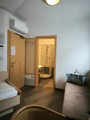 a room with a hallway with a door to a bathroom at Residence Hirzer in Lagundo
