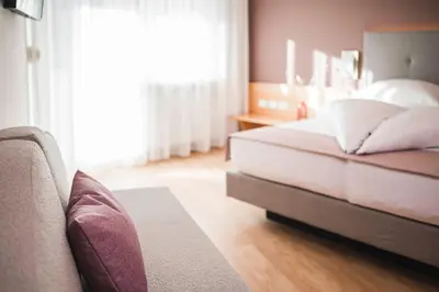 a bedroom with a bed and a couch at Residence Hirzer in Lagundo
