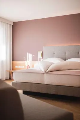 a bedroom with a large bed with a headboard at Residence Hirzer in Lagundo