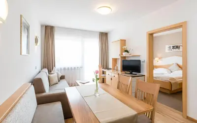 a living room with a room with a bed and a table at Residence Hirzer in Lagundo