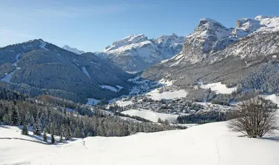 a snow covered mountain with a town in the distance at Residence Sas Vanna in La Villa