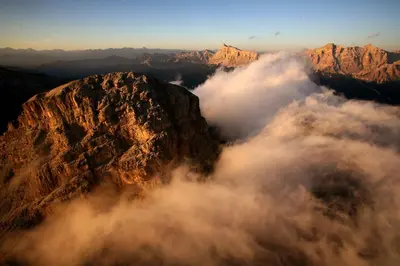 an aerial view of a mountain with clouds at Residence Sas Vanna in La Villa