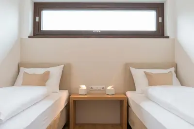 two beds in a room with a window at Untermargarethenhof in Lana