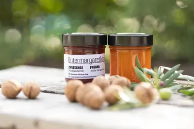 two jars of peanuts and hazelnuts on a table at Untermargarethenhof in Lana