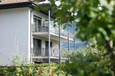 a white building with balconies on the side of it at Untermargarethenhof in Lana