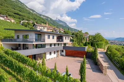 a house on the side of a hill at Tholr - Ferienwohnungen - Tramin in Termeno