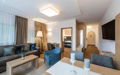a living room with a couch and a table at Appartementhaus Residence Hirzer in Tirolo