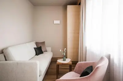 a living room with a couch and two chairs at Appartementhaus Residence Hirzer in Tirolo