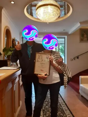 a man and woman holding up neon lights on their heads at Garni Franca b&b in Selva di Val Gardena