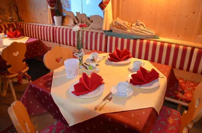 a table with red napkins on top of it at Garni Franca b&b in Selva di Val Gardena