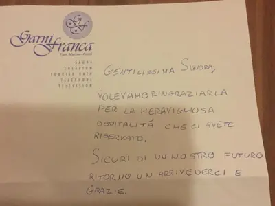 a menu for a restaurant with a bottle of wine at Garni Franca b&b in Selva di Val Gardena