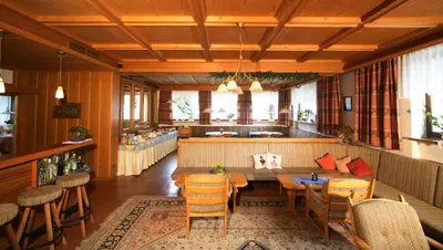 a restaurant with a table and chairs and a bar at Medesc in La Villa
