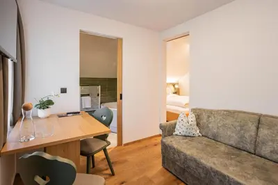 a living room with a couch and a table at Gasthof Albergo Dolomiten in Braies
