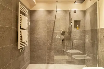 a bathroom with a shower and a toilet at Hotel Goldenes Roessl-adults only in Bressanone