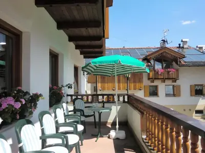 a bedroom with a bed with a book on it at Hotel Fiorenza in Campitello di Fassa
