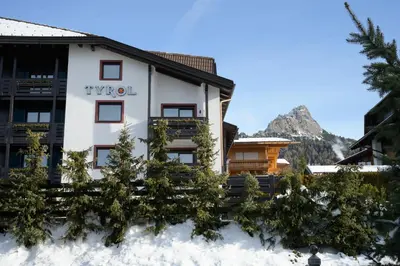 a hotel in the mountains in the snow at Hotel Tyrol in Selva di Val Gardena