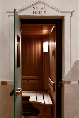 a wooden elevator with a bench in a building at Hotel Tyrol in Selva di Val Gardena