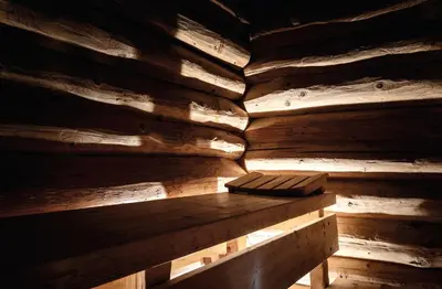 a wooden room with a bench in a sauna at Hotel Tyrol in Selva di Val Gardena