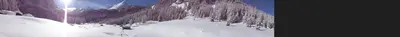 a skier is skiing down a snow covered slope at Hotel Albe in Rocca Pietore