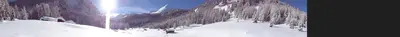 a person is skiing down a snow covered mountain at Hotel Albe in Rocca Pietore