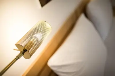 a microphone on a wall next to a bed at Mondschein Rooms in Lana