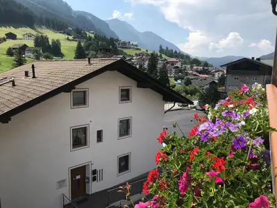 a view of a building with flowers in the foreground at Villa Aurelia in Ortisei
