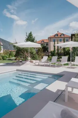 an aerial view of a resort with a pool and buildings at Hotel Traube in Bressanone