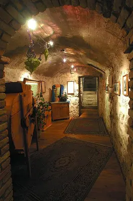 a hallway in a stone building with a tunnel at Hotel Al Forte in Arabba