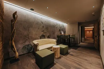 a lobby with a couch and a table at Vitalhotel Dosses in Santa Cristina in Val Gardena