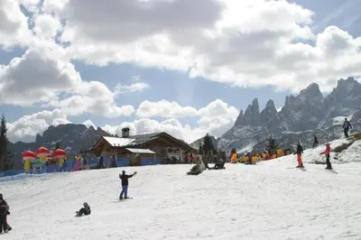 a snow covered mountain in the distance with a blue sky at Hotel Orsa Maggiore in Falcade
