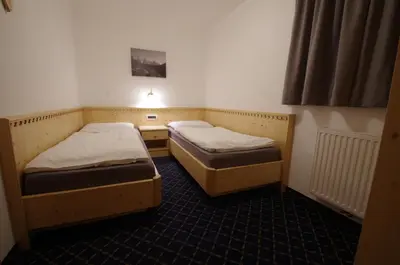 a room with two beds in a room at Villa Hubertus in Ortisei