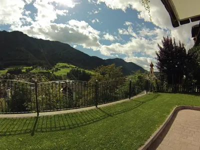 a fence with a view of a mountain at Villa Hubertus in Ortisei