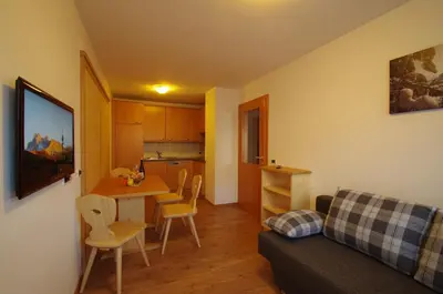 a living room with a couch and a table at Villa Hubertus in Ortisei